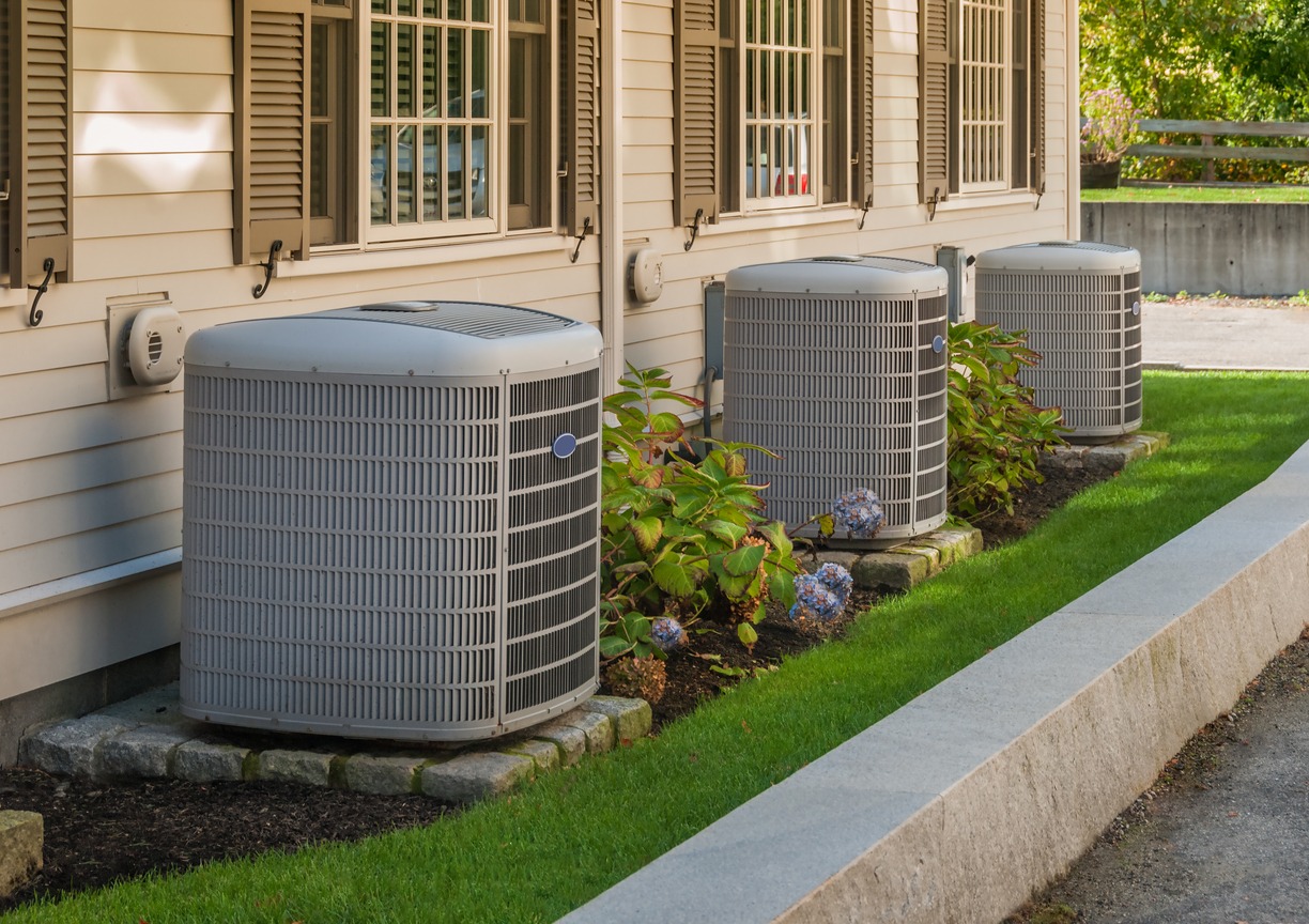 Heating and air conditioning inverters on the side of a condo